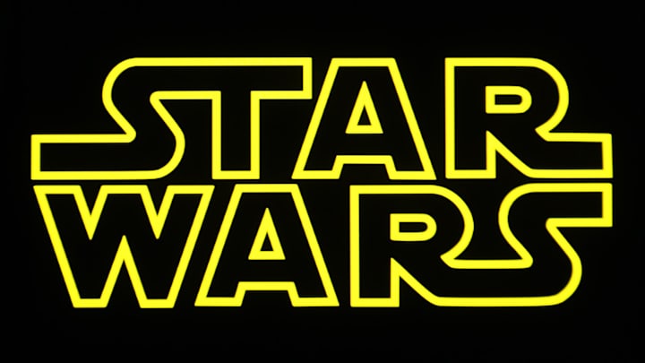 In this photo illustration, a Star Wars logo is seen. In this photo illustration, a Star Wars logo is seen.