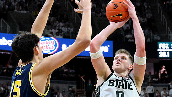 Jan 30, 2026; East Lansing, Michigan, USA; Michigan State Spartans forward Jaxon Kohler (0) shoots past Michigan Wolverines center Aday Mara (15) during the second half at Jack Breslin Student Events Center. Mandatory Credit: Dale Young-Imagn Images Jan 30, 2026; East Lansing, Michigan, USA; Michigan State Spartans forward Jaxon Kohler (0) shoots past Michigan Wolverines center Aday Mara (15) during the second half at Jack Breslin Student Events Center. Mandatory Credit: Dale Young-Imagn Images
