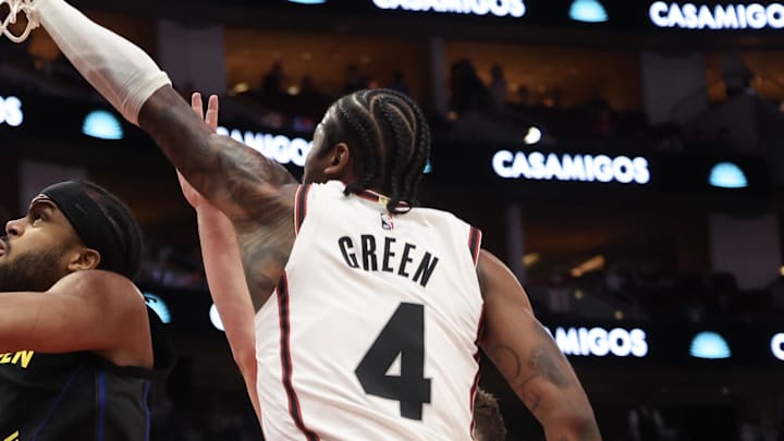 Feb 13, 2025; Houston, Texas, USA; Golden State Warriors guard Moses Moody (4) makes a basket against Houston Rockets guard Jalen Green (4) in the first half at Toyota Center. Mandatory Credit: Thomas Shea-Imagn Images