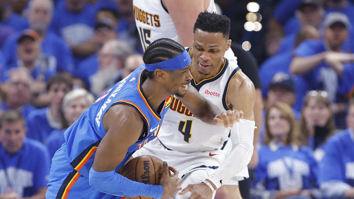 May 18, 2025; Oklahoma City, Oklahoma, USA; Oklahoma City Thunder guard Shai Gilgeous-Alexander (2) is fouled by Denver Nuggets guard Russell Westbrook (4) on a drive in the second quarter during game seven of the second round for the 2025 NBA Playoffs at Paycom Center. Mandatory Credit: Alonzo Adams-Imagn Images