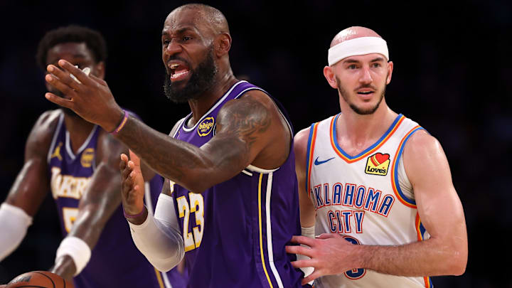 Feb 9, 2026; Los Angeles, California, USA;  Los Angeles Lakers forward LeBron James (23) argues with referee Josh Tiven (58) during the fourth quarter against the Oklahoma City Thunder at Crypto.com Arena. Mandatory Credit: Kiyoshi Mio-Imagn Images
