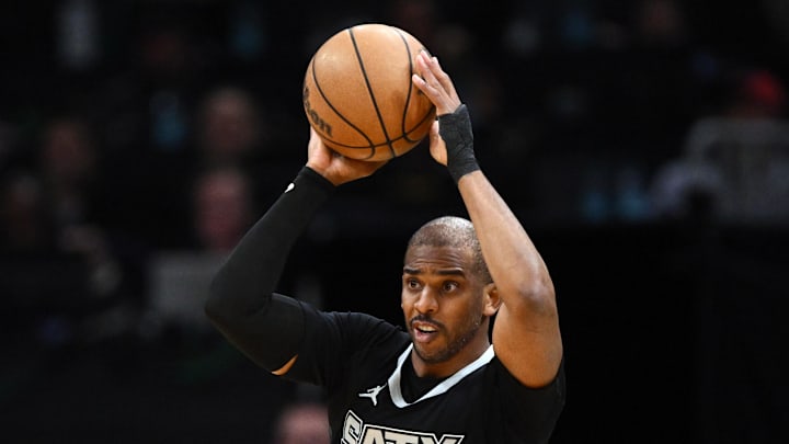 San Antonio Spurs guard Chris Paul looks to throw a pass.