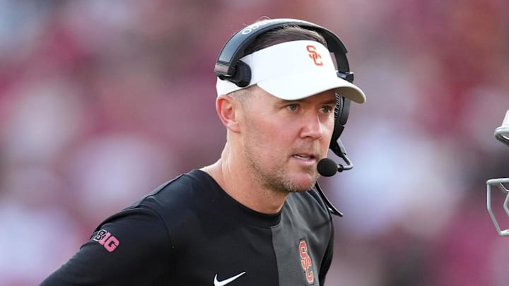 Aug 30, 2025; Los Angeles, California, USA; Southern California Trojans head coach Lincoln Riley talks with Southern California Trojans quarterback Husan Longstreet (4) in the second half against the Missouri State Bears at United Airlines Field at Los Angeles Memorial Coliseum. Mandatory Credit: Kirby Lee-Imagn Images