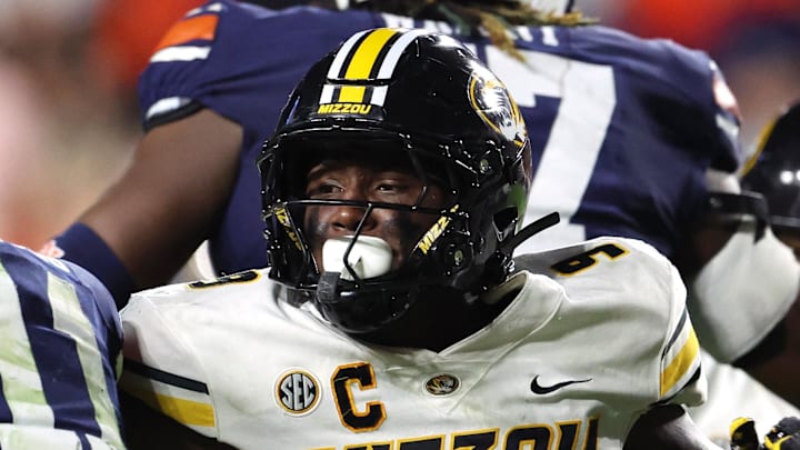 Oct 18, 2025; Auburn, Alabama, USA; Missouri Tigers defensive end Zion Young (9) moves in to tackle Auburn Tigers quarterback Jackson Arnold (11) during the fourth quarter at Jordan-Hare Stadium. Mandatory Credit: John Reed-Imagn Images Oct 18, 2025; Auburn, Alabama, USA; Missouri Tigers defensive end Zion Young (9) moves in to tackle Auburn Tigers quarterback Jackson Arnold (11) during the fourth quarter at Jordan-Hare Stadium. Mandatory Credit: John Reed-Imagn Images