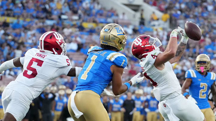 Sep 14, 2024; Pasadena, California, USA; Indiana Hoosiers linebacker Aiden Fisher (4) and defensive back D'Angelo Ponds (5) defend against UCLA Bruins wide receiver Rico Flores Jr. (1) in the first half at Rose Bowl. Mandatory Credit: Kirby Lee-Imagn Images Sep 14, 2024; Pasadena, California, USA; Indiana Hoosiers linebacker Aiden Fisher (4) and defensive back D'Angelo Ponds (5) defend against UCLA Bruins wide receiver Rico Flores Jr. (1) in the first half at Rose Bowl. Mandatory Credit: Kirby Lee-Imagn Images