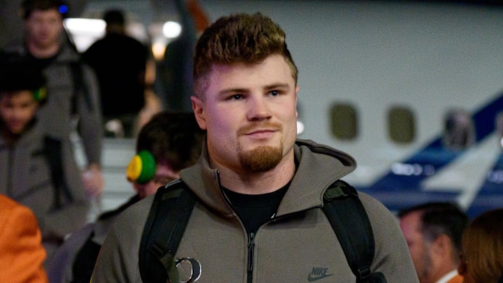 Oregon inside linebacker Bryce Boettcher walks the orange carpet as the Oregon Ducks arrive at Miami International Airport ahead of the Orange Bowl on Dec. 29, 2025, in Miami, Florida. Oregon inside linebacker Bryce Boettcher walks the orange carpet as the Oregon Ducks arrive at Miami International Airport ahead of the Orange Bowl on Dec. 29, 2025, in Miami, Florida.