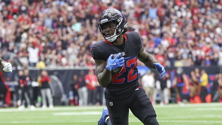 Oct 6, 2024; Houston, Texas, USA; Houston Texans running back Cam Akers (22) runs with the ball and scores a touchdown as Buffalo Bills cornerback Rasul Douglas (31) defends during the first quarter at NRG Stadium. Mandatory Credit: Troy Taormina-Imagn Images