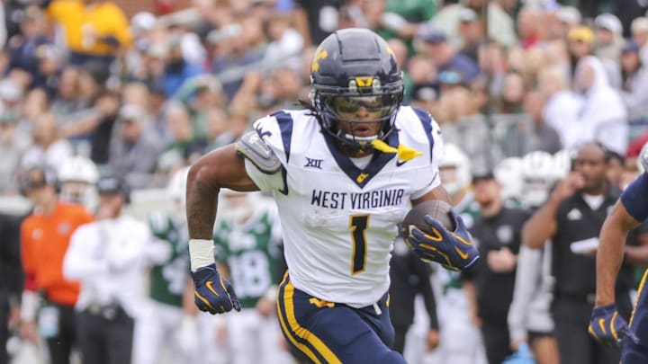 Sep 6, 2025; Athens, Ohio, USA; West Virginia Mountaineers running back Jahiem White (1) runs the ball for a touchdown during the first quarter against the Ohio Bobcats at Peden Stadium. Mandatory Credit: Ben Queen-Imagn Images