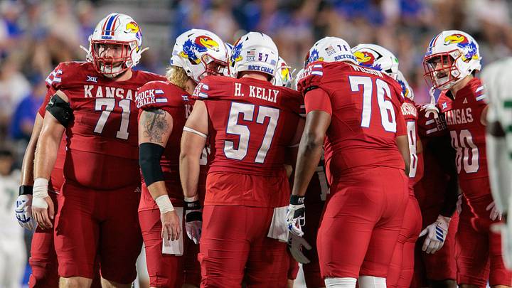 Aug 29, 2025; Lawrence, Kansas, USA; Kansas Jayhawks huddle during the second half against the Wagner Seahawks at David Booth Kansas Memorial Stadium. Mandatory Credit: William Purnell-Imagn Images Aug 29, 2025; Lawrence, Kansas, USA; Kansas Jayhawks huddle during the second half against the Wagner Seahawks at David Booth Kansas Memorial Stadium. Mandatory Credit: William Purnell-Imagn Images