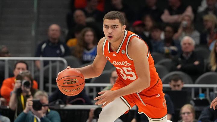 Mar 13, 2026; Charlotte, NC, USA; Miami (FL) Hurricanes guard Dante Allen (35) dribbles as Virginia Cavaliers guard Jacari White (6) defends in the first half at Spectrum Center. Mandatory Credit: Bob Donnan-Imagn Images