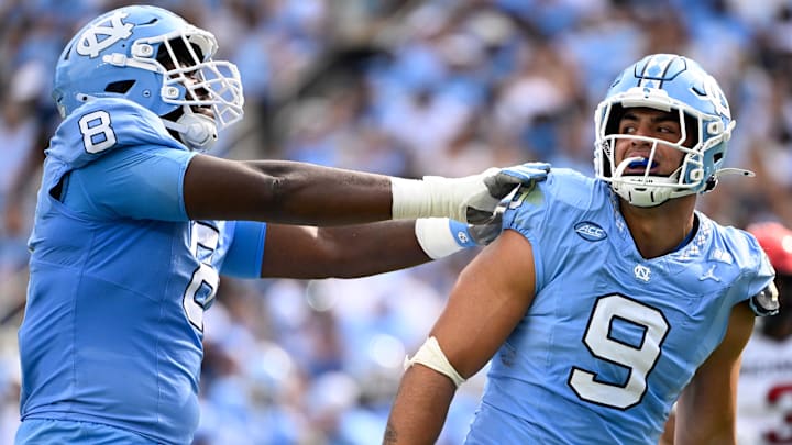 Sep 13, 2025; Chapel Hill, North Carolina, USA; North Carolina Tar Heels defensive lineman Melkart Abou-Jaoude (9 ) celebrates with defensive lineman Smith Vilbert (8) after making a sack in the first quarter at Kenan Stadium. Mandatory Credit: Bob Donnan-Imagn Images