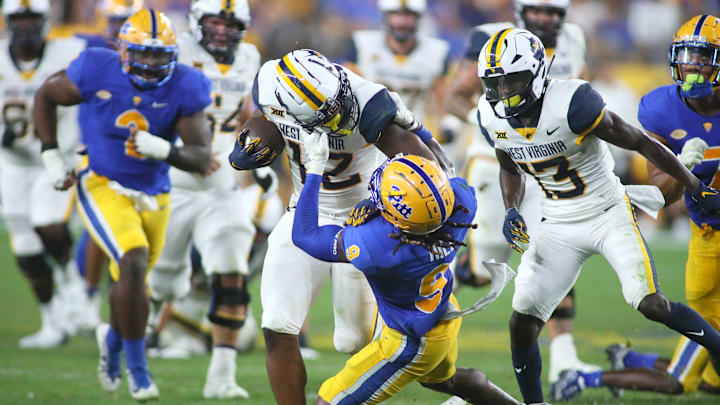 Brandon Hill (9) of the Pittsburgh Panthers drags down CJ Donaldson (12) of the West Virginia Mountaineers during the second half of the Backyard Brawl at Acrisure Stadium in Pittsburgh, PA on September 1, 2022.

Pitt Vs West Virginia Backyard Brawl