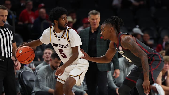 Dec 6, 2025; Phoenix, Arizona, USA; Arizona State Sun Devils guard Moe Odum (5) dribbles against Oklahoma Sooners guard Jeff Nwankwo (3) in the first half at PHX Arena. Mandatory Credit: Anna Carrington-Imagn Images