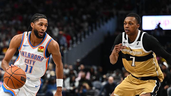 Mar 21, 2026; Washington, District of Columbia, USA; Oklahoma City Thunder guard Isaiah Joe (11) dribbles past Washington Wizards guard Bub Carrington (7) during the second half at Capital One Arena. Mandatory Credit: Brad Mills-Imagn Images