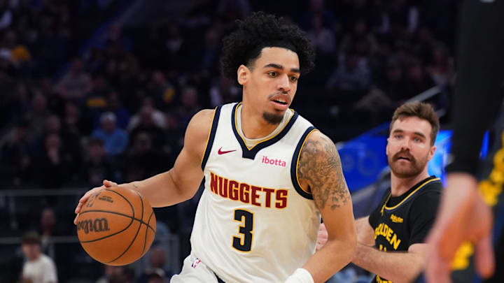 Feb 22, 2026; San Francisco, California, USA;  Denver Nuggets guard Julian Strawther (3) dribbles past Golden State Warriors guard Pat Spencer (61) in the third quarter at Chase Center.