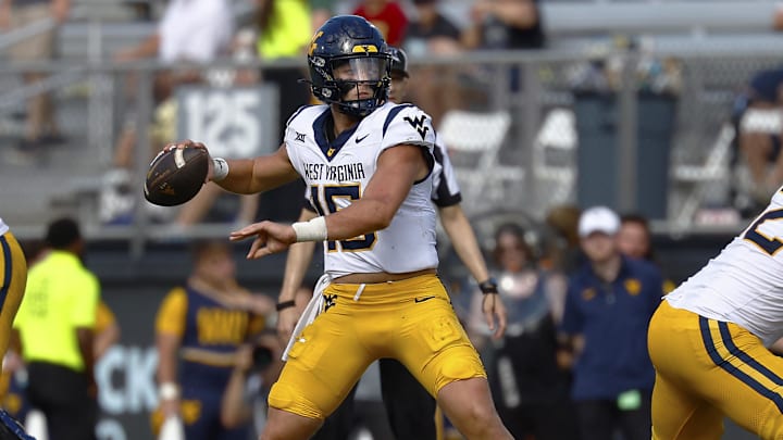 Oct 18, 2025; Orlando, Florida, USA;  West Virginia Mountaineers quarterback Scotty Fox Jr. (15) makes a second half pass against the Central Florida Knights at Acrisure Bounce House.