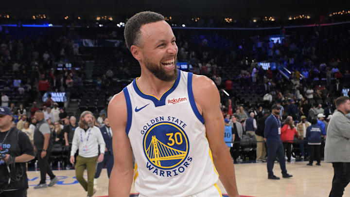 Warriors guard Stephen Curry smiles on the court after defeating the Clippers during the play-in tournament.