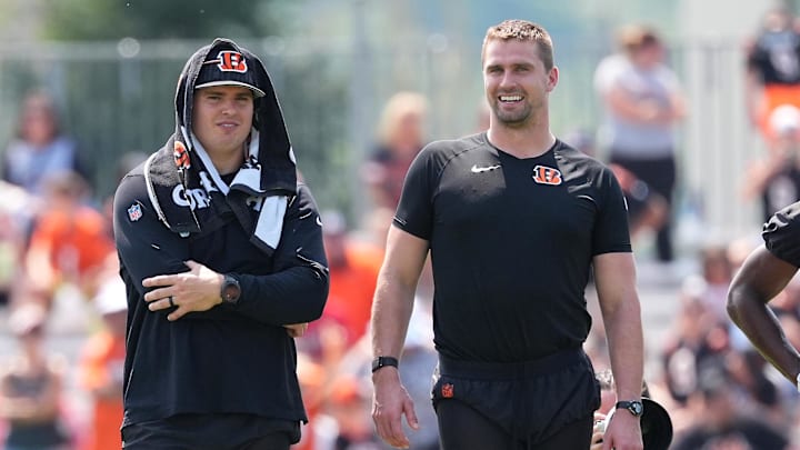 Jul 26, 2024; Cincinnati, OH, USA; Cincinnati Bengals defensive end Trey Hendrickson (91) and defensive end Sam Hubbard (94) observe play during training camp practice at Kettering Health Practice Fields. Mandatory Credit: Kareem Elgazzar-Imagn Images