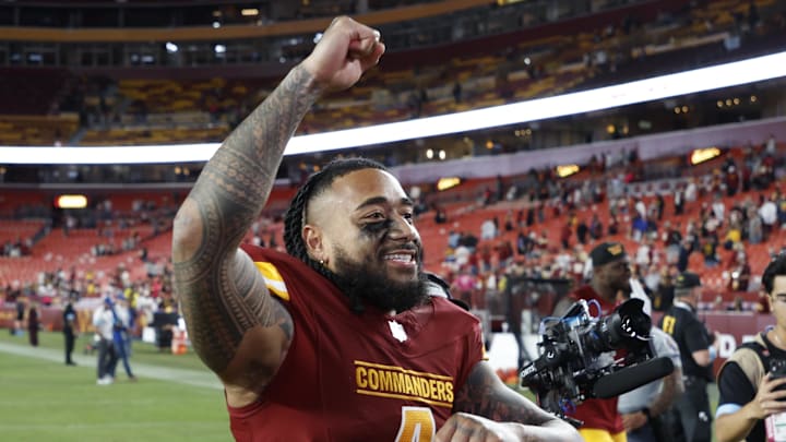 Oct 20, 2024; Landover, Maryland, USA; Washington Commanders linebacker Frankie Luvu (4) celebrates while leaving the field after the game against the Carolina Panthers at Northwest Stadium. Mandatory Credit: Geoff Burke-Imagn Images