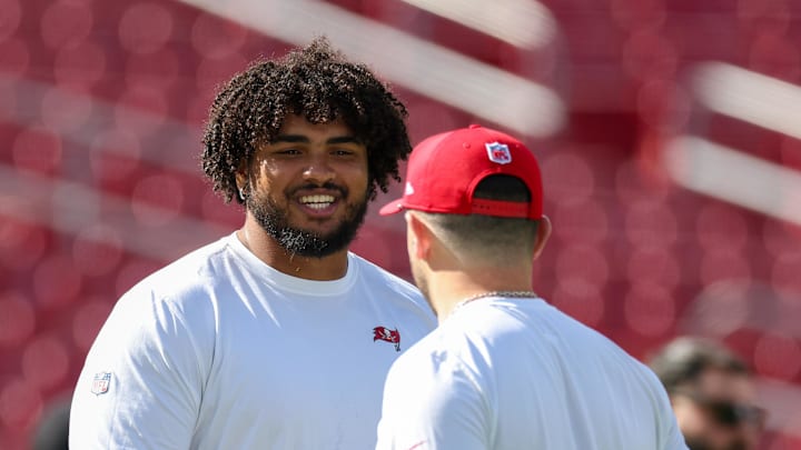 Tampa Bay Buccaneers offensive tackle Tristan Wirfs (78) and quarterback Baker Mayfield (6) warms up before a game.