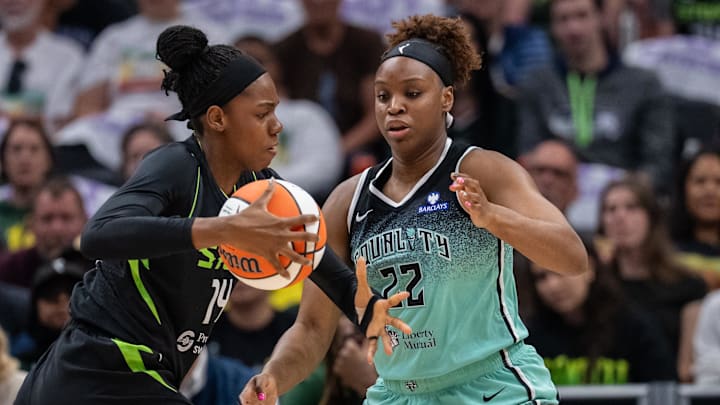 Sep 5, 2025; Seattle, Washington, USA;  Seattle Storm center Dominique Malonga (14) drives to the basket bainst New York Liberty forward Kennedy Burke (22) during the first half at Climate Pledge Arena. Mandatory Credit: Stephen Brashear-Imagn Images