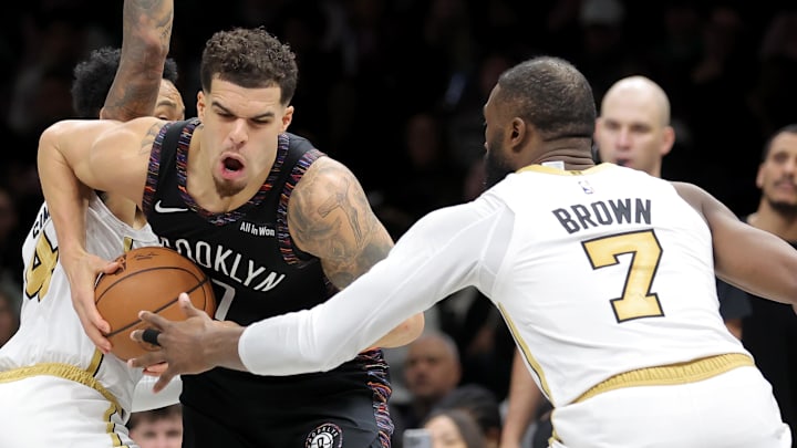 Jan 23, 2026; Brooklyn, New York, USA; Brooklyn Nets forward Michael Porter Jr. (17) controls the ball against Boston Celtics guards Baylor Scheierman (55) and Anfernee Simons (4) and Jaylen Brown (7) during the fourth quarter at Barclays Center. Mandatory Credit: Brad Penner-Imagn Images