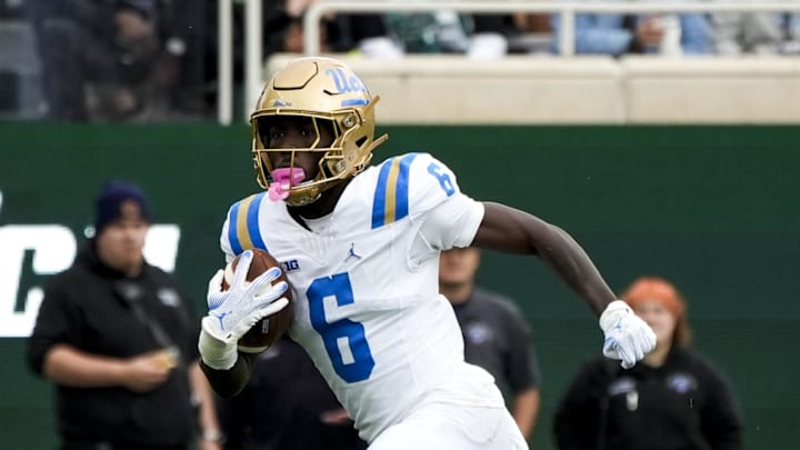 Oct 11, 2025; East Lansing, Michigan, USA; UCLA Bruins running back Anthony Woods (6) runs the ball against the Michigan State defense in the second quarter at Spartan Stadium. Mandatory Credit: Brendan Mullin-Imagn Images