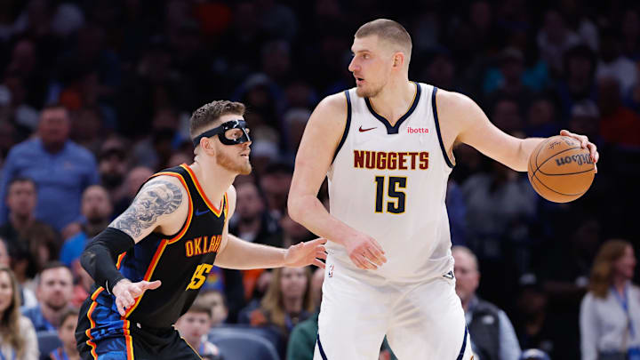 Mar 9, 2025; Oklahoma City, Oklahoma, USA; Oklahoma City Thunder center Isaiah Hartenstein (55) defends Denver Nuggets center Nikola Jokic (15) during the second half at Paycom Center. Mandatory Credit: Alonzo Adams-Imagn Images