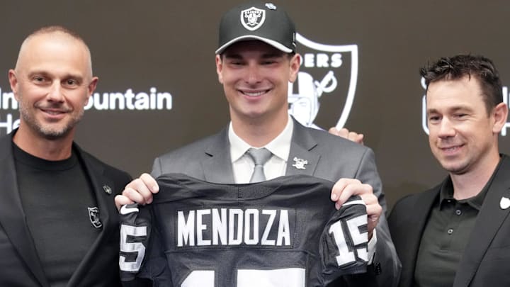 Las Vegas Raiders quarterback Fernando Mendoza (center) poses with jersey with general manager John Spytek (left) and head coach Klint Kubiak