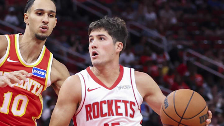 Oct 6, 2025; Houston, Texas, USA; Houston Rockets guard Reed Sheppard (15) dribbles the ball as Atlanta Hawks forward Zaccharie Risacher (10) defends during the first quarter at Toyota Center. Mandatory Credit: Troy Taormina-Imagn Images