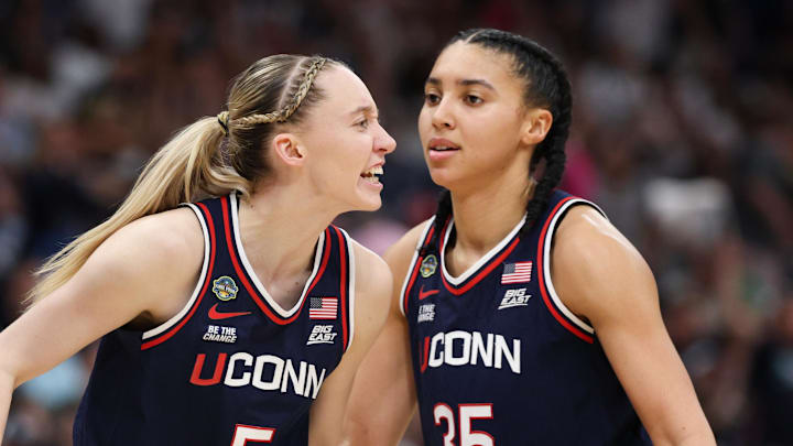 Apr 6, 2025; Tampa, FL, USA; Connecticut Huskies guard Paige Bueckers (5) reacts with teammates guard Ashlynn Shade (12) and guard Azzi Fudd (35) during the second half against the South Carolina Gamecocks of the national championship of the women's 2025 NCAA tournament at Amalie Arena. Mandatory Credit: Nathan Ray Seebeck-Imagn Images