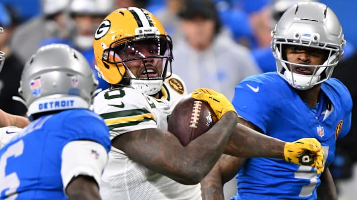 Nov 27, 2025; Detroit, Michigan, USA; Green Bay Packers running back Josh Jacobs (8) runs the ball against Detroit Lions cornerback Terrion Arnold (6) during the second quarter at Ford Field.