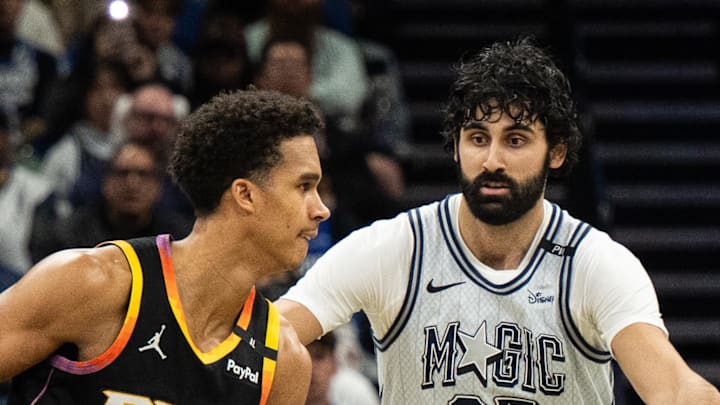 Phoenix Suns forward Iso Ighodaro dribbles the ball against Orlando Magic center Goga Bitadze. Phoenix Suns forward Iso Ighodaro dribbles the ball against Orlando Magic center Goga Bitadze.