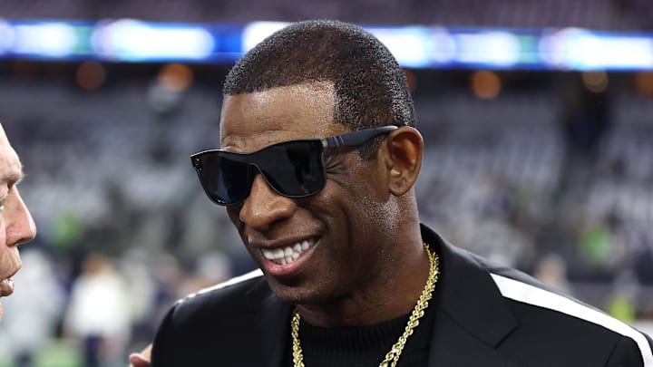 Nov 30, 2023; Arlington, Texas, USA; Colorado Buffaloes head coach Deion Sanders (right) talks with Dallas Cowboys owner Jerry Jones before the game against the Seattle Seahawks at AT&T Stadium. Mandatory Credit: Tim Heitman-Imagn Images