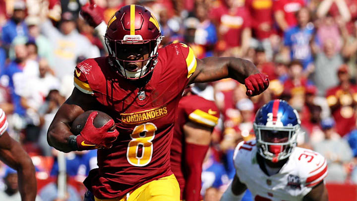 Sep 15, 2024; Landover, Maryland, USA; Washington Commanders running back Brian Robinson Jr. (8) runs the ball during the third quarter against the New York Giants at Commanders Field. Mandatory Credit: Peter Casey-Imagn Images