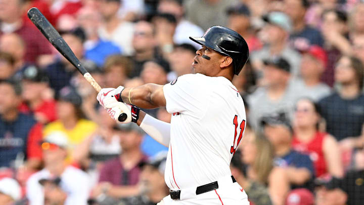 Jun 25, 2024; Boston, Massachusetts, USA; Boston Red Sox third baseman Rafael Devers (11) watches the ball after hitting a solo home run against the Toronto Blue Jays during the second inning at Fenway Park.