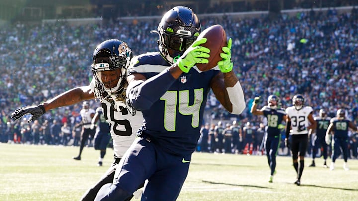 Oct 31, 2021; Seattle, Washington, USA; Seattle Seahawks wide receiver DK Metcalf (14) catches a touchdown against Jacksonville Jaguars cornerback Shaquill Griffin (26) during the second quarter at Lumen Field. Mandatory Credit: Joe Nicholson-Imagn Images