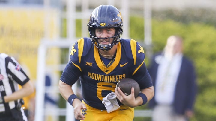 Sep 13, 2025; Morgantown, West Virginia, USA; West Virginia Mountaineers quarterback Nicco Marchiol (8) runs the ball during the second quarter against the Pittsburgh Panthers at Milan Puskar Stadium. Mandatory Credit: Ben Queen-Imagn Images