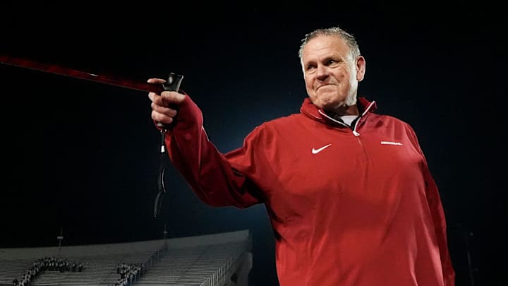 Arkansas' head coach Sam Pittman points to his players and Arkansas fans with his cane after Arkansas defeated Texas Tech 36-26 in the AutoZone Liberty Bowl in Memphis, Tenn., on Friday, December 27, 2024.