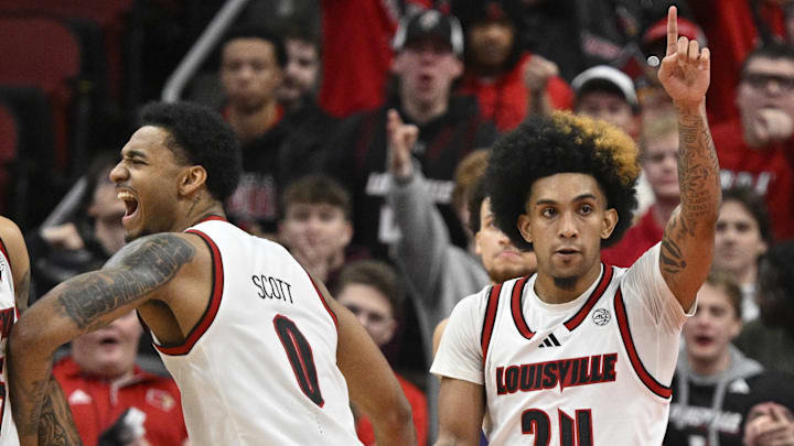 Jan 7, 2025; Louisville, Kentucky, USA; Louisville Cardinals forward James Scott (0) celebrates with guard Terrence Edwards Jr. (5) and guard Chucky Hepburn (24) during the second half against the Clemson Tigers at KFC Yum! Center. Louisville defeated Clemson 74-64. Jan 7, 2025; Louisville, Kentucky, USA; Louisville Cardinals forward James Scott (0) celebrates with guard Terrence Edwards Jr. (5) and guard Chucky Hepburn (24) during the second half against the Clemson Tigers at KFC Yum! Center. Louisville defeated Clemson 74-64.