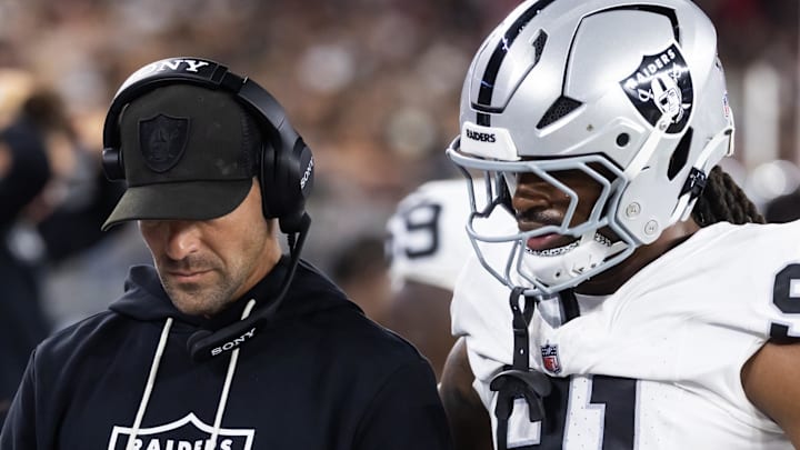 Aug 23, 2025; Glendale, Arizona, USA; Las Vegas Raiders defensive line coach Rob Leonard with defensive end Jahfari Harvey (91) against the Arizona Cardinals during a preseason NFL game at State Farm Stadium. Mandatory Credit: Mark J. Rebilas-Imagn Images