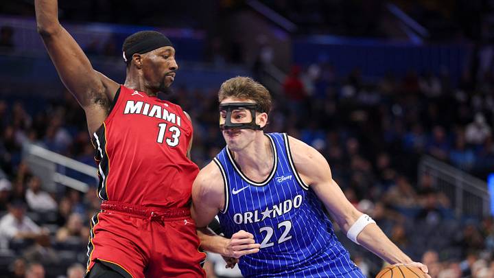 Dec 5, 2025; Orlando, Florida, USA; Orlando Magic forward Franz Wagner (22) drives to the basket past Miami Heat center Bam Adebayo (13) in the third quarter at Kia Center. Mandatory Credit: Nathan Ray Seebeck-Imagn Image