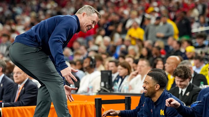 Dusty May is coaching Michigan in part because Indiana retained Mike Woodson for another season.