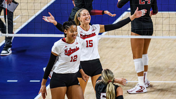 Andi Jackson (15) and Taylor Landfair (12) celebrate a Husker point. 