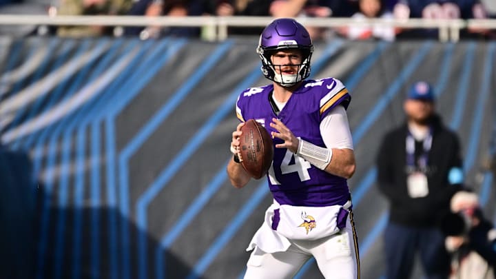 Nov 24, 2024; Chicago, Illinois, USA; Minnesota Vikings quarterback Sam Darnold (14) looks to pass against the Chicago Bears during the second quarter at Soldier Field. Nov 24, 2024; Chicago, Illinois, USA; Minnesota Vikings quarterback Sam Darnold (14) looks to pass against the Chicago Bears during the second quarter at Soldier Field.