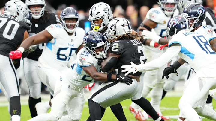 Oct 12, 2025; Paradise, Nevada, USA; Tennessee Titans free safety Xavier Woods (25) tackles Las Vegas Raiders running back Ashton Jeanty (2) during the first half at Allegiant Stadium. Mandatory Credit: Stephen R. Sylvanie-Imagn Images Oct 12, 2025; Paradise, Nevada, USA; Tennessee Titans free safety Xavier Woods (25) tackles Las Vegas Raiders running back Ashton Jeanty (2) during the first half at Allegiant Stadium. Mandatory Credit: Stephen R. Sylvanie-Imagn Images