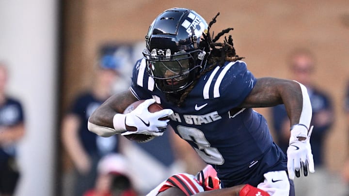 Sep 14, 2024; Logan, Utah, USA;  Utah State Aggies running back Rahsul Faison (3) is brought down by Utah Utes linebacker Levani Damuni (3) after a short gain in the second half at Merlin Olsen Field at Maverik Stadium. Mandatory Credit: Jamie Sabau-Imagn Images