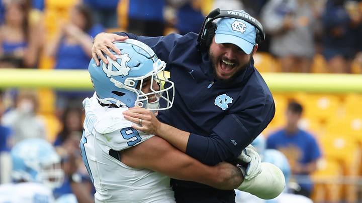 Oct 10, 2026; Pittsburgh, Pennsylvania, USA; North Carolina Tar Heels defensive lineman Melkart Abou Jaoude (9) celebrates with outside linebackers Coach Ty Nichols (right) after a defensive stop against the Pittsburgh Panthers during the fourth quarter at Acrisure Stadium. Mandatory Credit: Charles LeClaire-Imagn Images Oct 10, 2026; Pittsburgh, Pennsylvania, USA; North Carolina Tar Heels defensive lineman Melkart Abou Jaoude (9) celebrates with outside linebackers Coach Ty Nichols (right) after a defensive stop against the Pittsburgh Panthers during the fourth quarter at Acrisure Stadium. Mandatory Credit: Charles LeClaire-Imagn Images