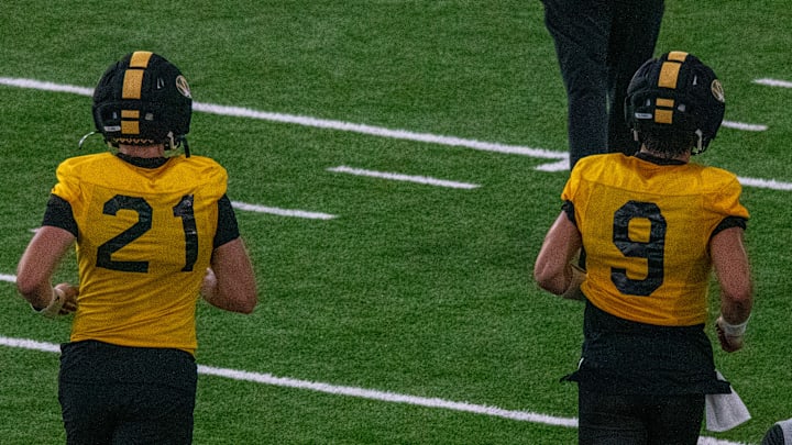 Aug 18, 2025; Columbia, MO, USA; Missouri Tigers quarterbacks Sam Horn (21) and Beau Pribula (9) jog to a drill at a fall camp practice at Stephens In