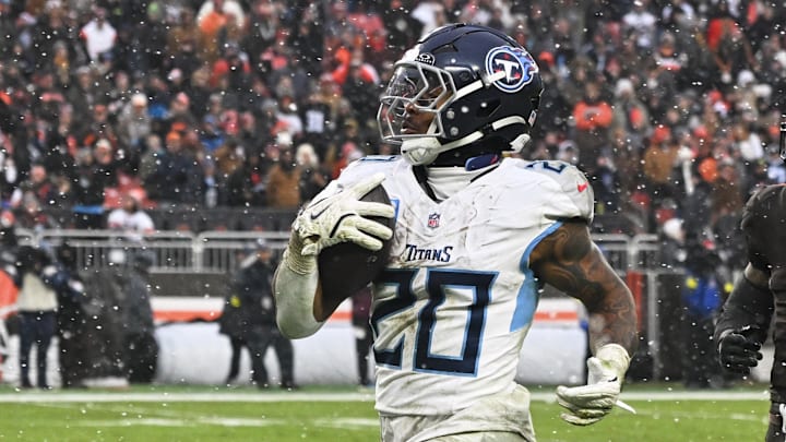 Dec 7, 2025; Cleveland, Ohio, USA; Tennessee Titans running back Tony Pollard (20) runs for a thirty-two yard touchdown against Cleveland Browns safety Grant Delpit (9) during the third quarter at Huntington Bank Field. Mandatory Credit: Ken Blaze-Imagn Images